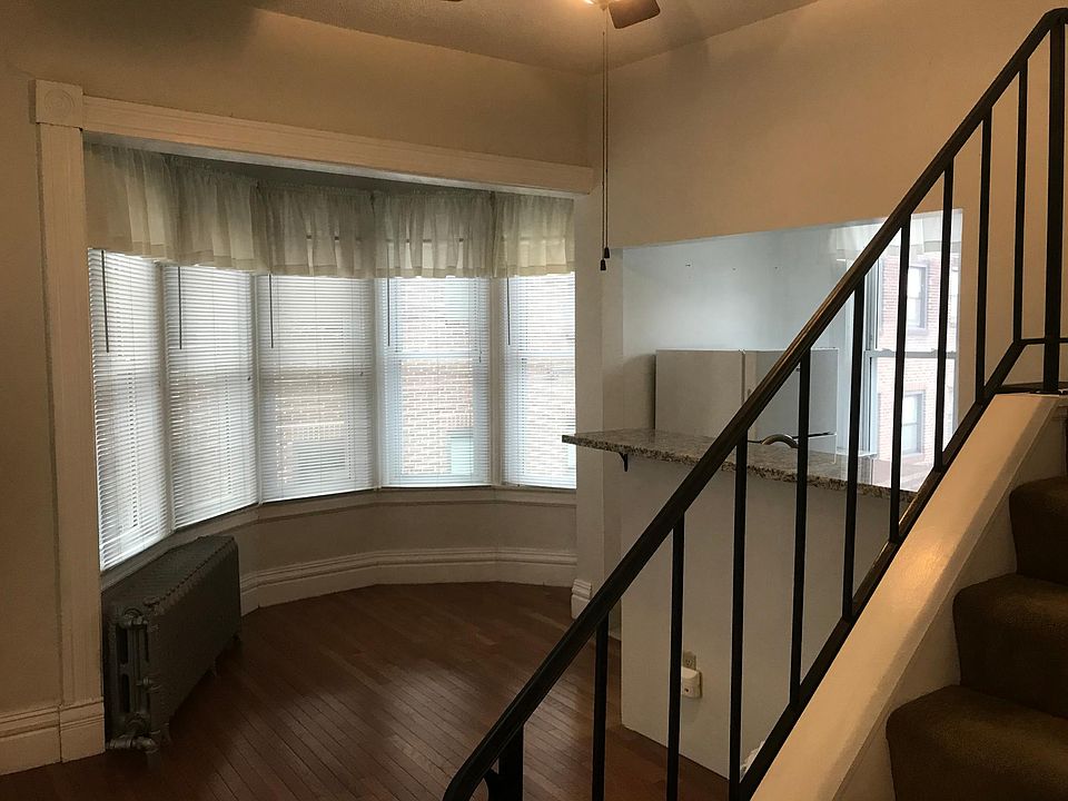 From entry door looking toward bay window and kitchen area. Lots of light
