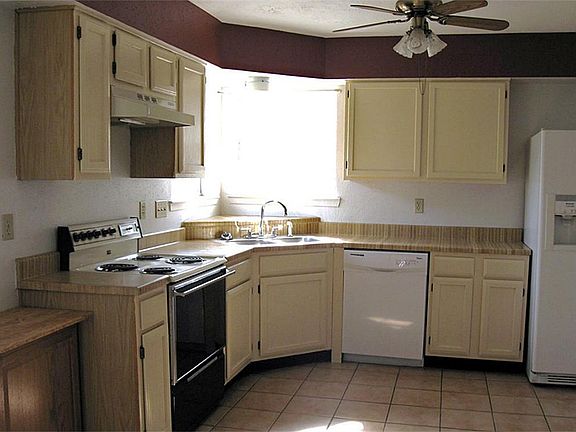 Kitchen w/ refrigerator and new dishwasher.