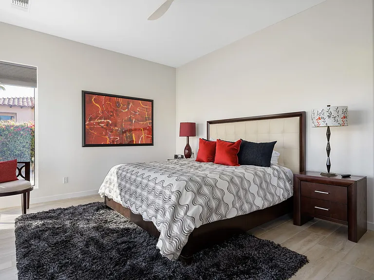 Primary king bedroom with smart TV opening up to rear of home.