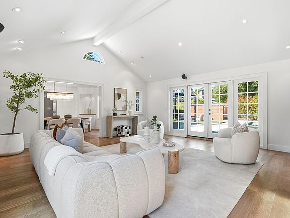 Family room with vaulted ceiling overlooking the pool