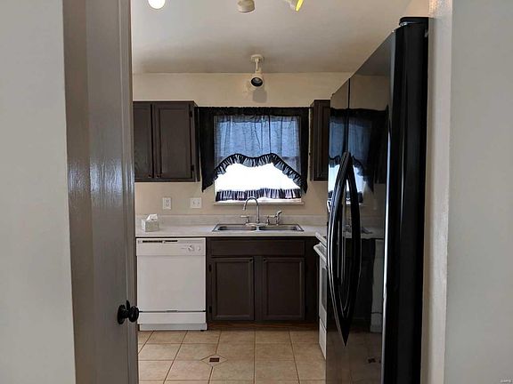 Looking in kitchen, nice window overlooks the level backyard!