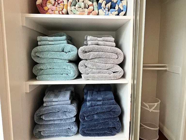 Spacious linen closet stocked with plush towels for five guests, extra pool towels, and soft hair-drying towels combining convenience with a touch of luxury.