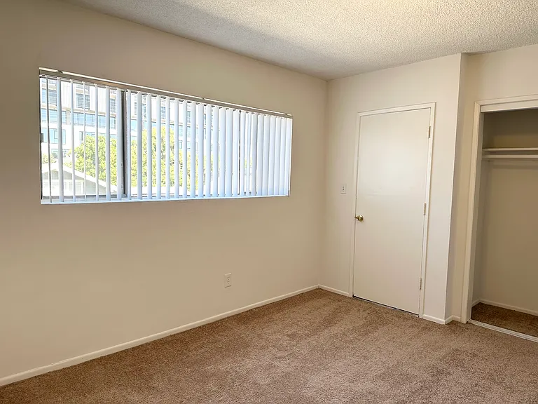 Bedroom with large window and lots of closet space