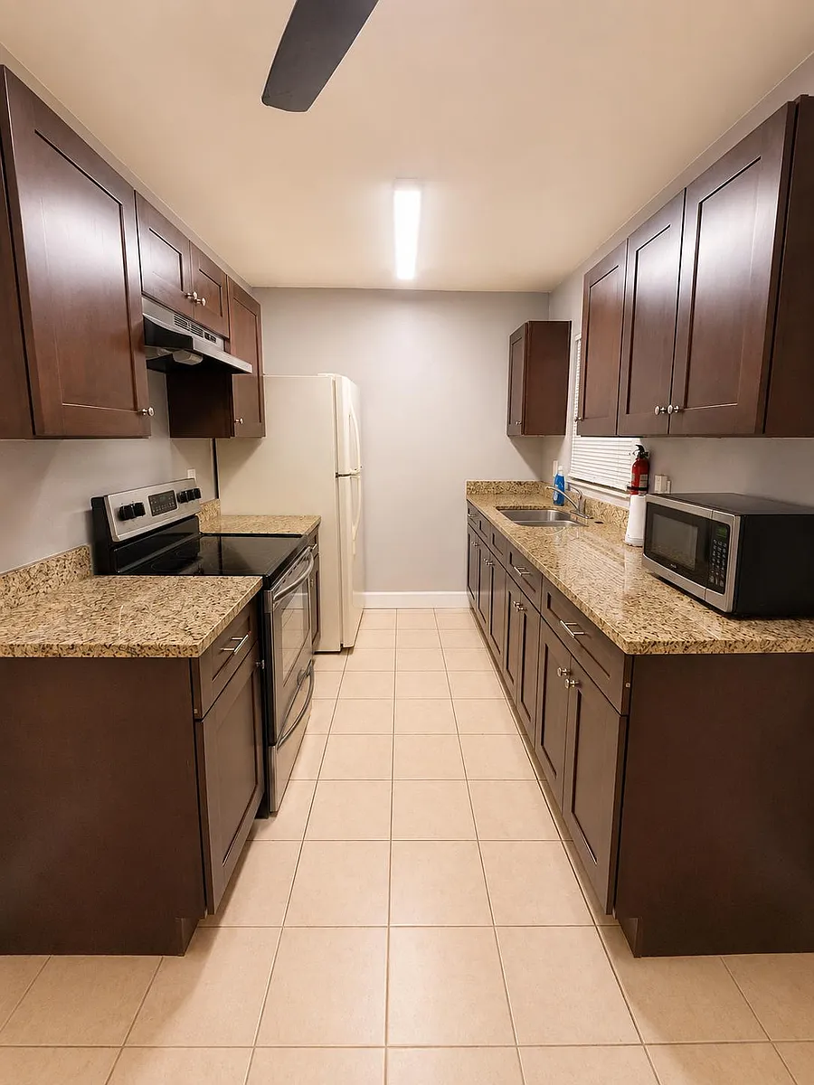 Galley kitchen with granite-look counters, ample cabinet storage, and a full appliance set including range, fridge, and micro - Pleasant Valley Ct