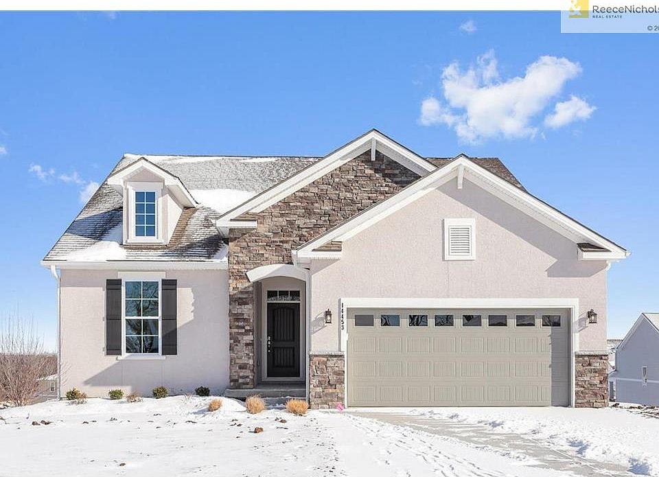 Gorgeous French Country exterior with stone and stucco!  Also featuring James Hardie siding on sides and back of home.