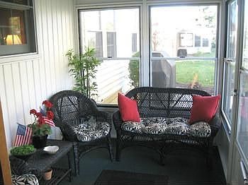 A very pleasant enclosedscreened porch overlooks the back yard