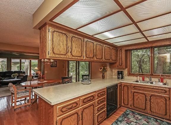 KITCHEN/DINING AREA OVER LOOKING PRIVATE SECLUDED BACK YARD AREA, HARDWOOD FLOORS, EAT IN COUNTER AREA!