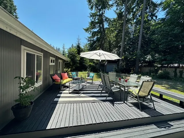 French doors off the dining and kitchen lead to the back yard and exterior deck.
