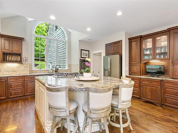 Updated kitchen with amazing circular island for seating, it's 5 feet by 7.5 feet - so much space w/ double thick granite and st