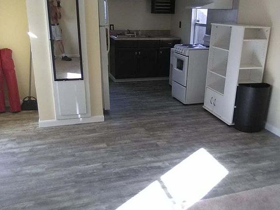 The kitchette. It has a range with range hood, a kitchen sink and refrigerator.