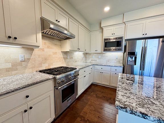 Bright east-facing kitchen with top of the line appliances and granite countertops