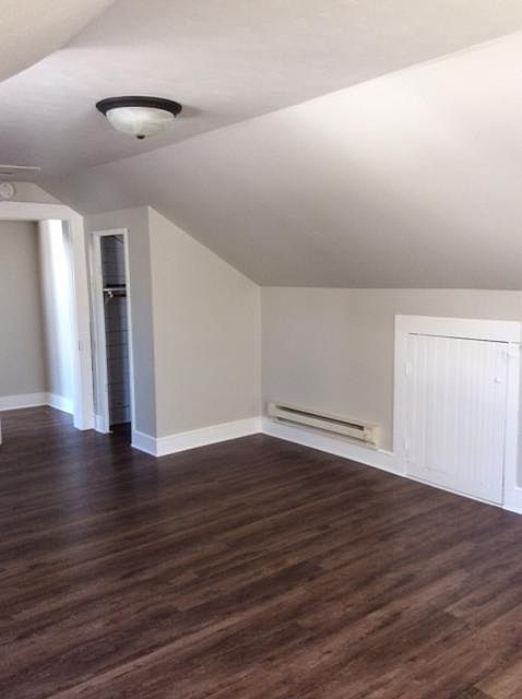 Another view of the bedroom, storage area behind small door