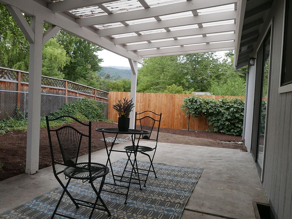 Relax with Chai tea or morning coffee on the covered patio under the Honeycrisp Apple tree. Fencing discourages deer from munching on the 3 varieties of grapevines and away from the garden plot.