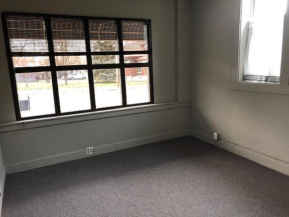 The bedroom has a number of electrical outlets and the tinted, front windows face the street.