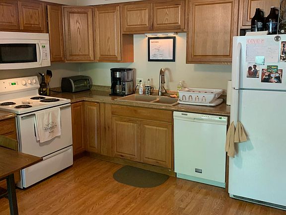 Updated kitchen has recent stove, microwave, dishwasher, refrigerator, upgraded faucet, composite sink and recent countertops and cabinets.