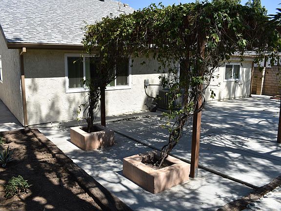 backyard trellis covered bbq area