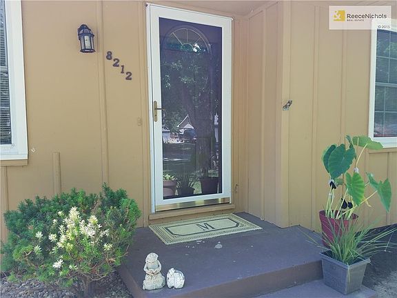 Lovely Greenery and Beautiful Shining Glass Storm Door Makes An Inviting Entrance Into Home!