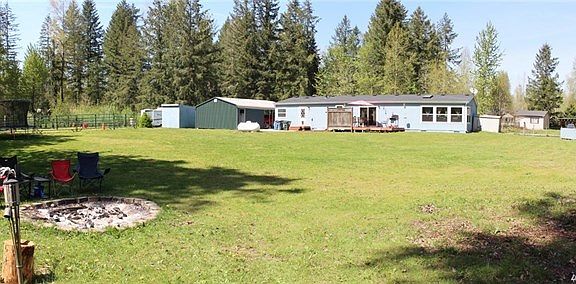 Rea view, expansive lawn area for pets and play.  Fire pit, deck off back of home perfect to enjoy a bit of sunshine.