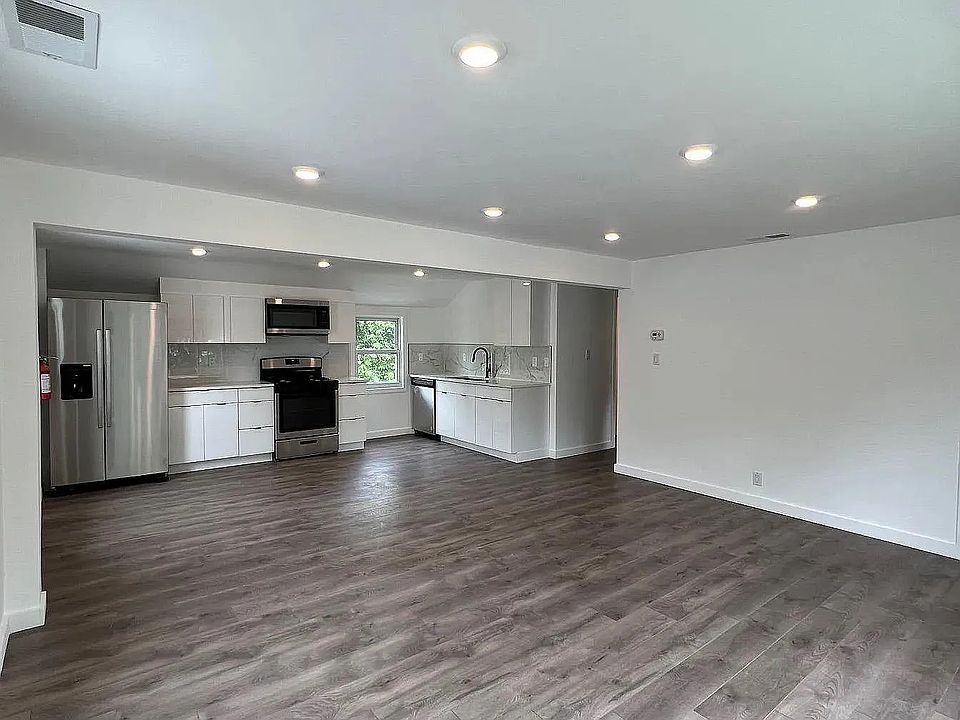 Spacious open-concept layout with recessed lighting and modern wide-plank flooring.