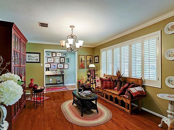 A view of the back of the home and patio from the lush back yard.