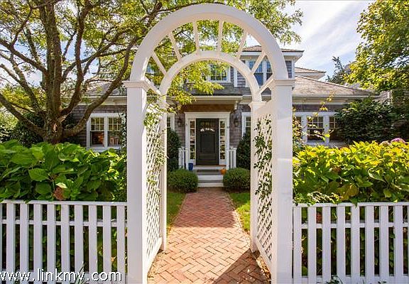 Welcome arch, rose covered in summer.