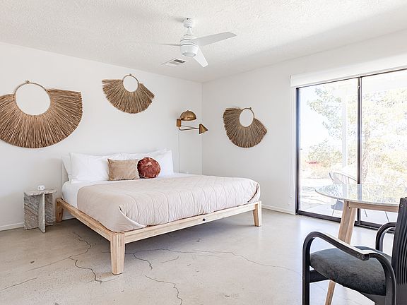 Master bedroom with attached bathroom, desk, and walk-in closet