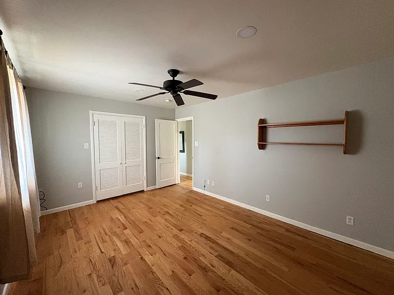 Bedroom on main floor - oak shelving and closet