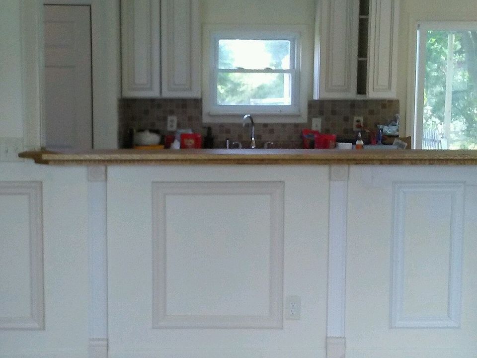 view from living room of kitchen bar area