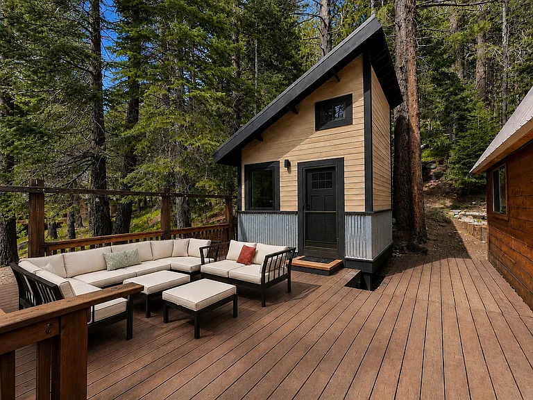 Detached flex space with forest views and outdoor deck (note there is additional deck space with a bbq and additional table and chairs not able to fit in the picture)