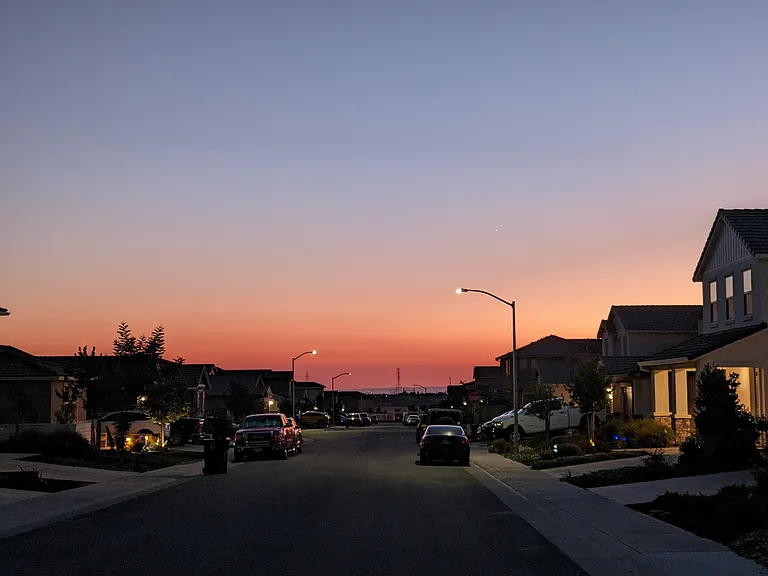Experience breathtaking sunsets from your new home in Rancho Cordova. This house offers picturesque evening views with vibrant hues of orange and pink lighting up the sky, providing a serene and beautiful backdrop to your everyday life.