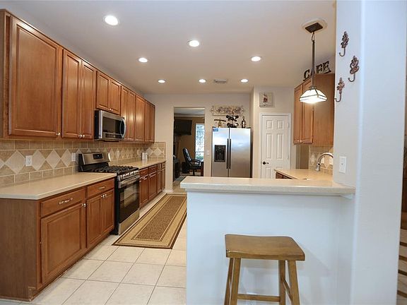 You'll love all the counterspace in this open kitchen. The bar has space for bar stools, and room to add an island or island cart if you'd like.