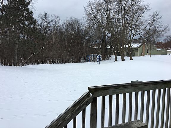 Wooded views and playset behind the home.