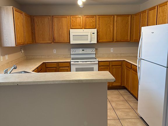 Kitchen with breakfast bar and view to backyard