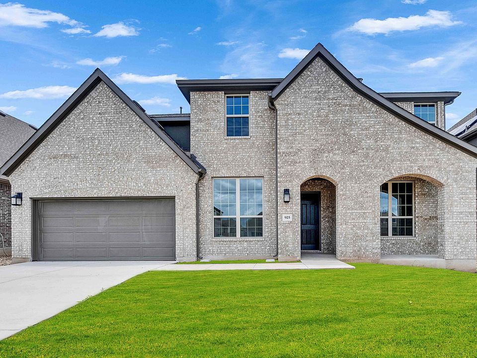 This Hawkes Landing home features exquisite brickwork and a graceful arched entrance, exuding timele