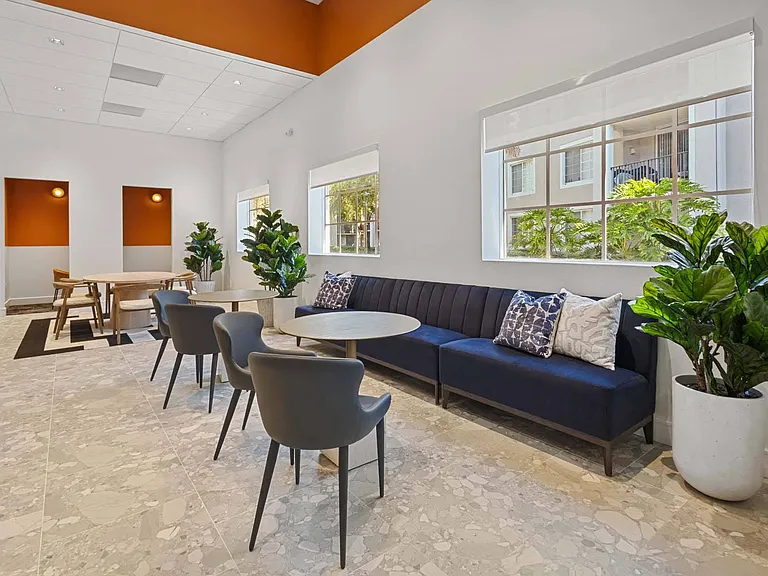 Relax in the spacious lounge, featuring a large, comfortable couch and a sleek coffee table, ideal for both relaxation and socializing.