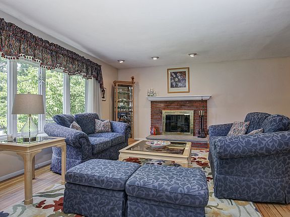 Living room with fireplace & bow window