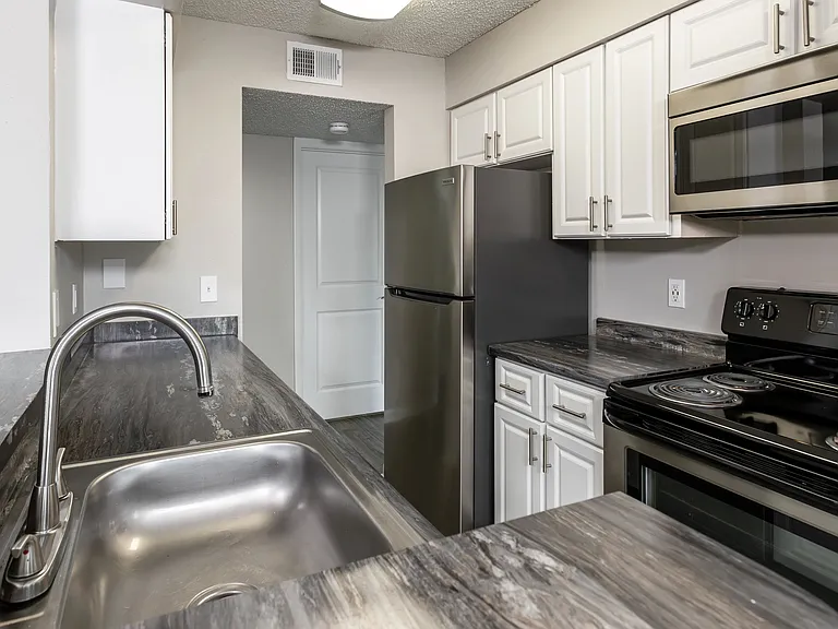 Experience the chic side of cooking in our fully-equipped kitchens, where abundant cabinetry and expansive counterspace meet culinary excellence.
