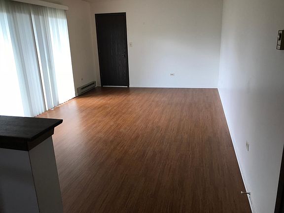 Living room from kitchen to door into apartment