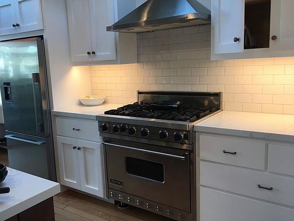 Chefs kitchen with professional range and giant island