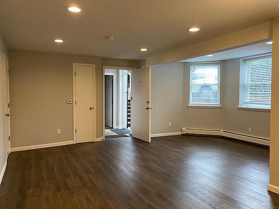 entry into living room, with storage and coat closets