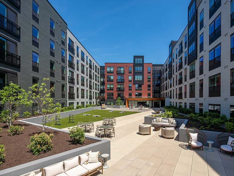 Courtyard with seating and cornhole