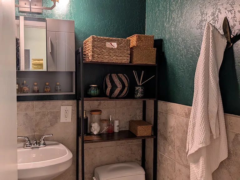 Bathroom with fresh paint (bathtub with shower to the left).