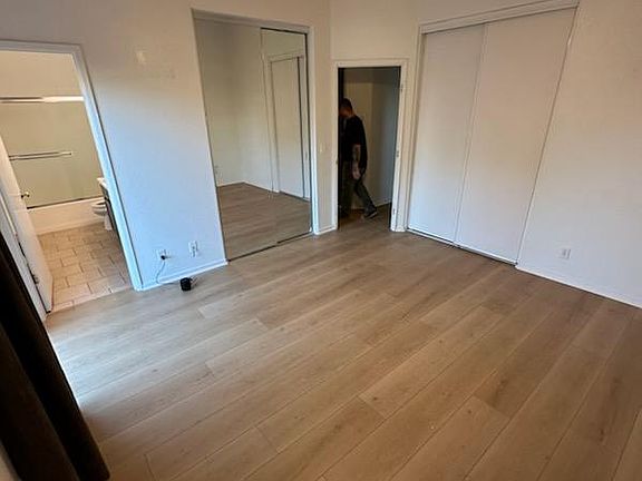 Master bedroom, full bathroom on the left, next to mirrow closet doors, entrance door on the right and second closet on the far right.