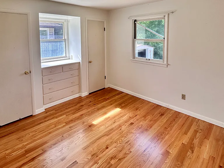 2nd main floor bedroom with dual closets and built-in dresser