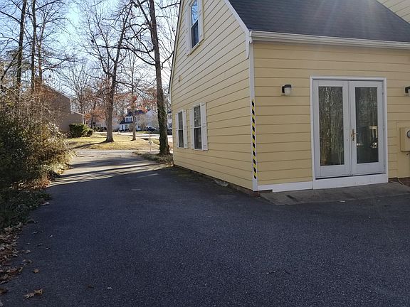 Rear view - towards road - large paved driveway and parking 