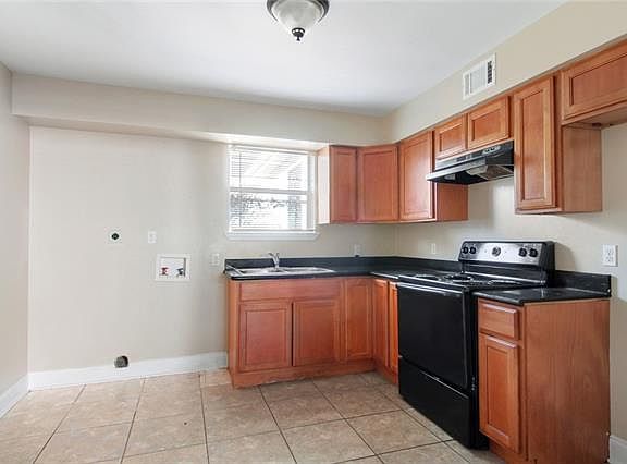 Kitchen with washer dryer hookups. Includes refrigerator not shown in this photo