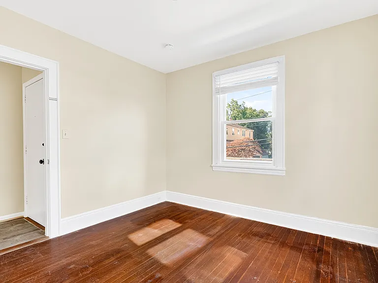 Bedroom with hardwood floors.