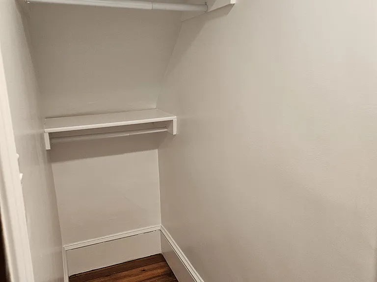 1st floor: closet with multiple racks and shelves.