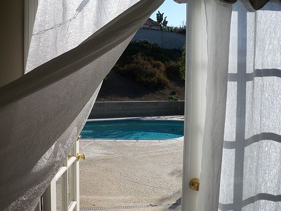 Master br french doors open to pool & jacuzzi