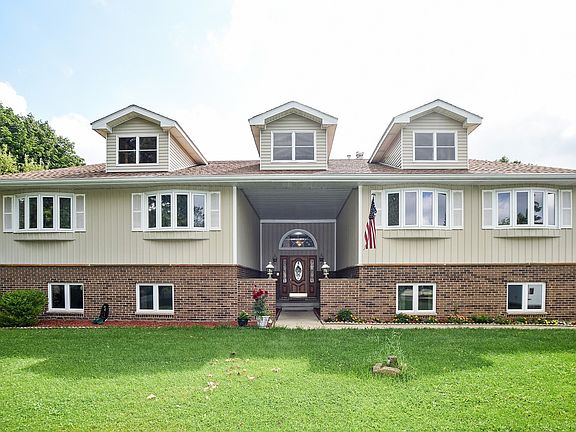 Brick beauty with dormer accents and newer roof
